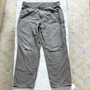 Carhartt distressed carpenter pants with some stains and holes. #10015
